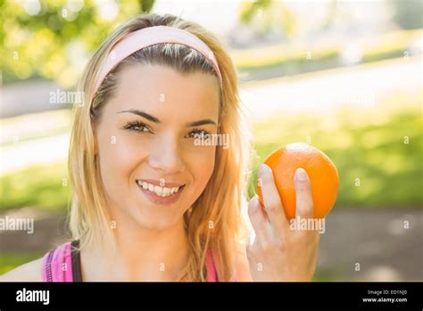 Fit Blonde Holding An Orange Stock Photo Alamy