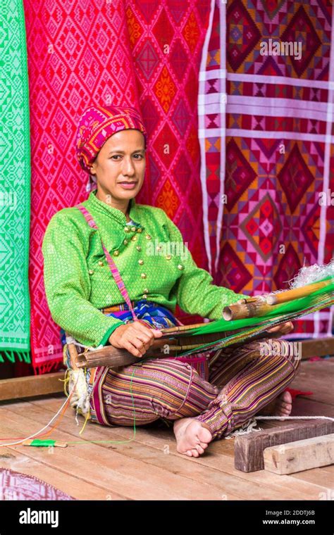 Evelinda Otong Hamja wearing traditional Yakan clothes weaving at the Yakan Weaving Center in ...