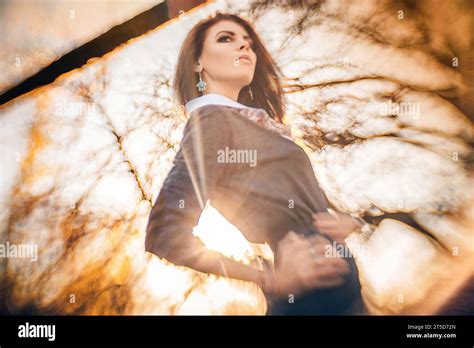 In This Mesmerizing Portrait A Brunette Woman Takes Center Stage Amidst The Enchanting Colors