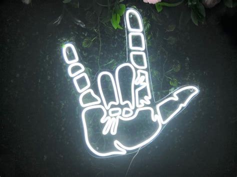 A Neon Sign That Has A Hand On It