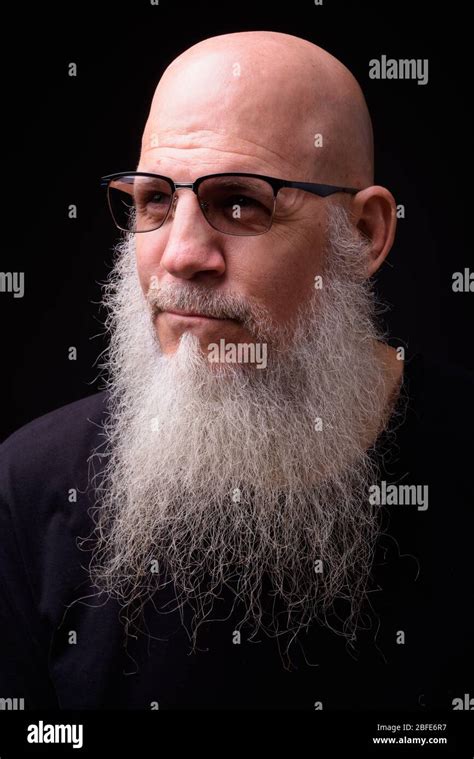 Mature Bald Bearded Man Against Black Background Stock Photo Alamy