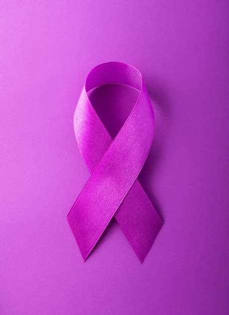 Premium Photo World Cancer Day Purple Ribbon On A Purple Background