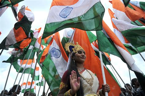 Download India Independence Day Woman Surrounded By Flags Picture