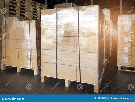 Stack Of Shipment Boxes Wrapping Plastic On Wooden Pallets At Interior