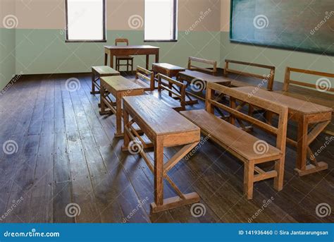 Antique Classroom In School With Rows Of Empty Wooden Desks Stock Photo