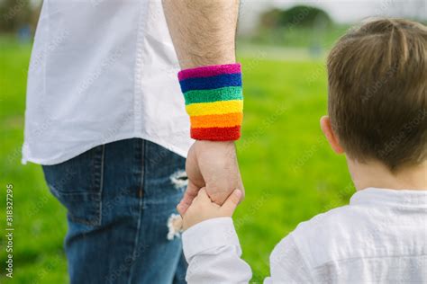Gay Father Holding His Son S Hand In A Park Parental Concept And Sexual Equality Stock Photo