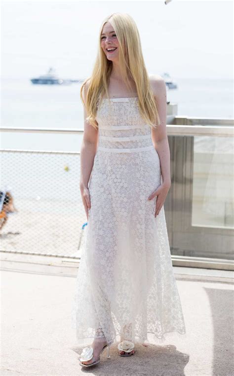 Elle Fanning In A White Dress Leaves Hotel Martinez During The 76th Annual Cannes Film Festival