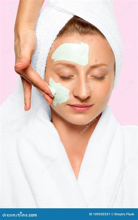 Beauty Spa Woman With Facial Clay Mask And Cucumbers On Eyes Stock