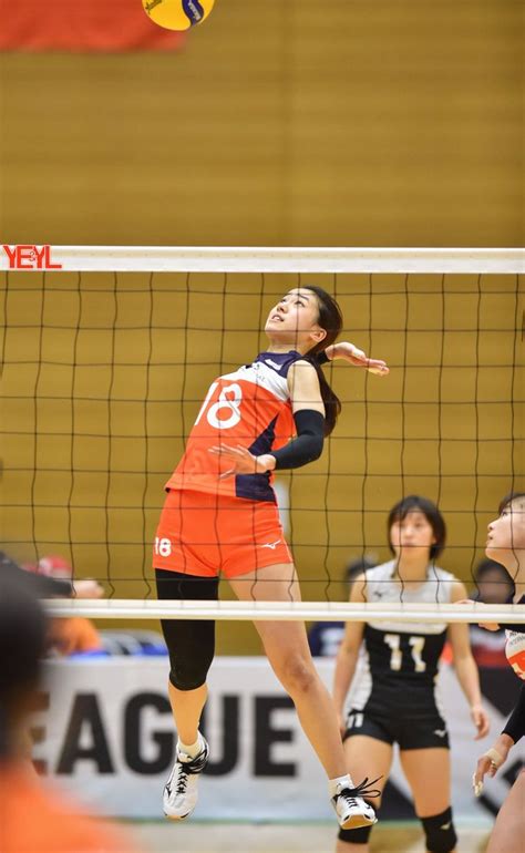 A Volleyball Player Jumps To Hit The Ball Over The Net While Other