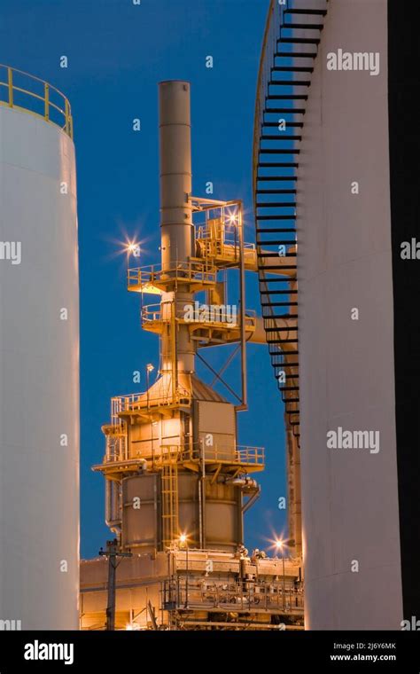 Oil And Gas Storage Tanks With Towers At Refinery At Dusk Montreal