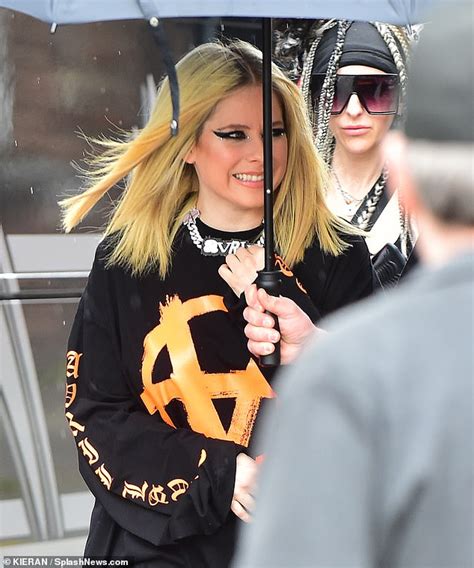 Avril Lavigne Puts On An Edgy Display In A White Blouse And Leather