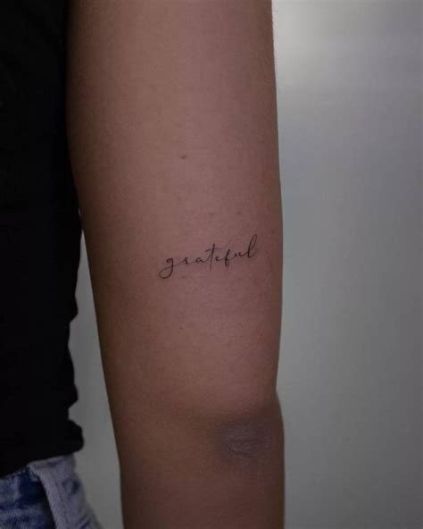 Grateful Lettering Tattoo Located On The Tricep