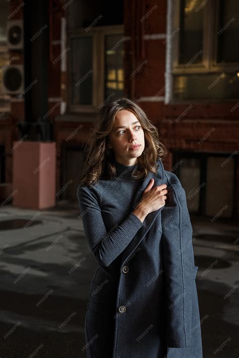 Premium Photo Young Thoughtful Girl In Gray Coat And Turtleneck Poses