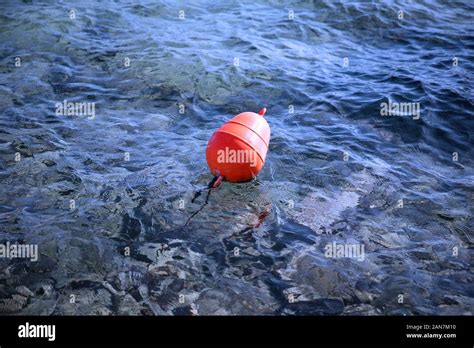 Orange Buoy Floating In Calm Blue Water Stock Image Stock Photo Alamy