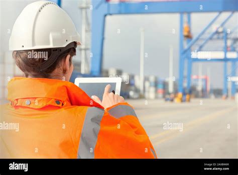 Female Dock Worker Using Digital Tablet At Shipyard Stock Photo Alamy