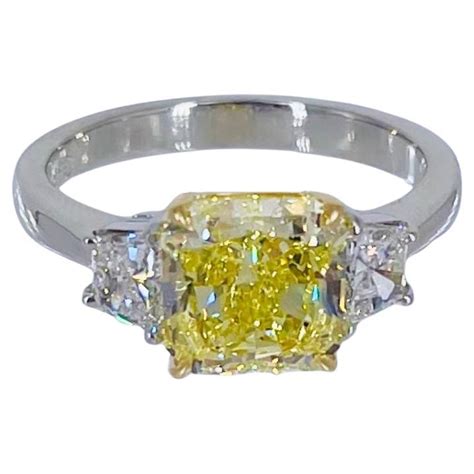 Gia Fancy Intense Yellow Diamond Radiant Three Stone Ring In Platinum