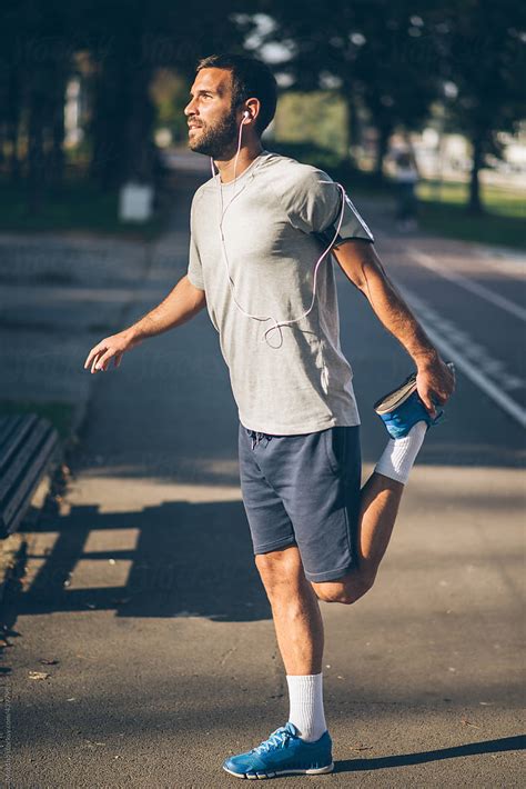 Man Stretching Before Running By Stocksy Contributor Mosuno Stocksy