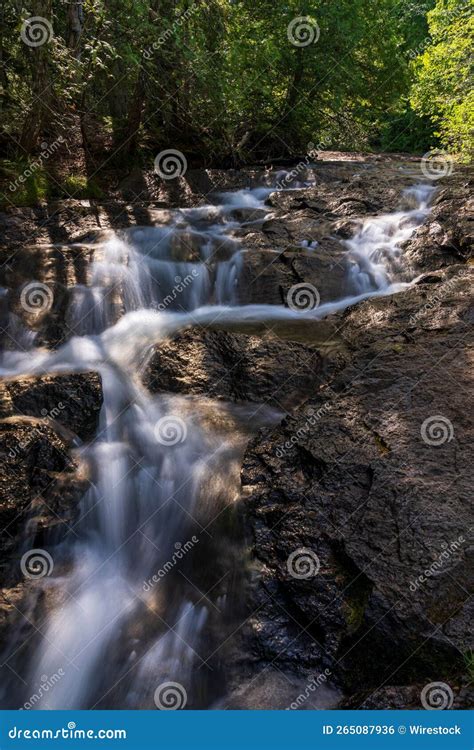 Vertical Shot Of A Waterfall Flowing Over The Rocks In Keweenaw