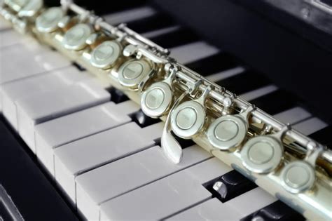 Premium Photo | Flute on piano keys closeup