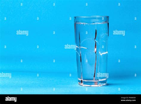 Transparent Glass With Mineral Water On A Blue Background With Space