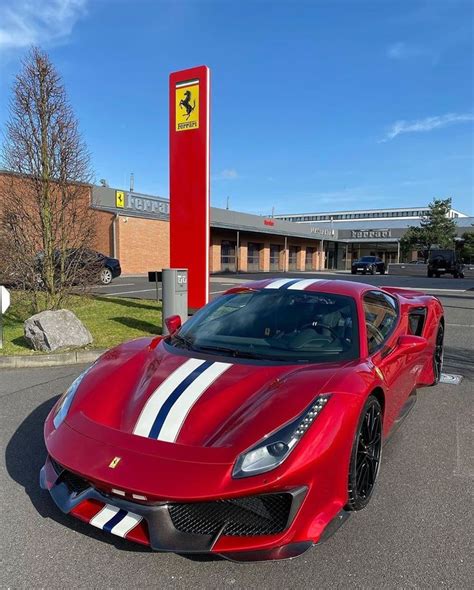 A Red Sports Car Parked In Front Of A Gas Station