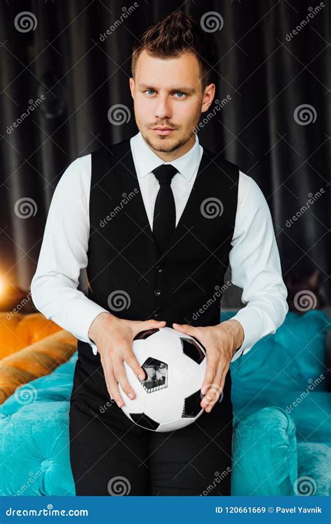 Stylish Athletic Man In A Business Costume Vest Holding A Soccer Ball