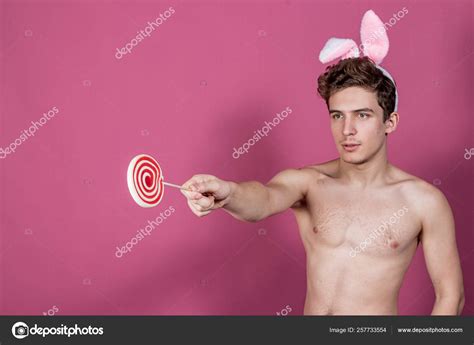 Funny Naked Guy Wearing Bunny Ears Holding Lollipop Over Pink Background Stock Photo By