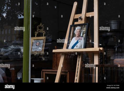 Easel in an antique shop window with portrait of Queen Elizabeth II in ...