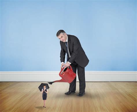Premium Photo Mature Businessman Watering Tiny Businesswoman Against