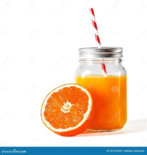 Glass Jar With A Tube With Freshly Squeezed Orange Juice Stands On A