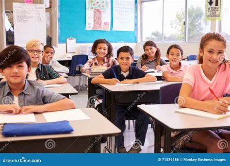 Smiling Elementary School Kids Sitting at Desks in Classroom Stock ...