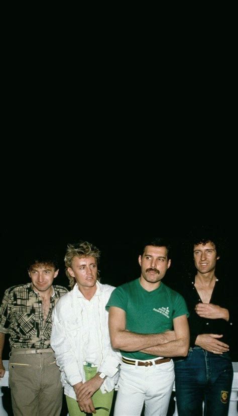 Three Men Standing in Front of a Dark Background