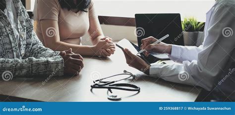 Doctor Or Physician Writing Diagnosis And Giving A Medical Prescription