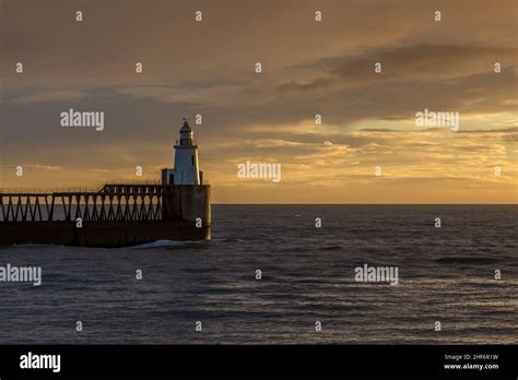 A glorious morning at Blyth beach, with a beautiful sunrise over the old wooden Pier stretching ...