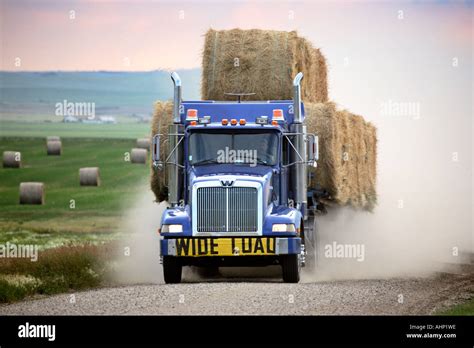 Truck Hauling Hay Bales On A Country Road In Scenic Saskatchewan Stock