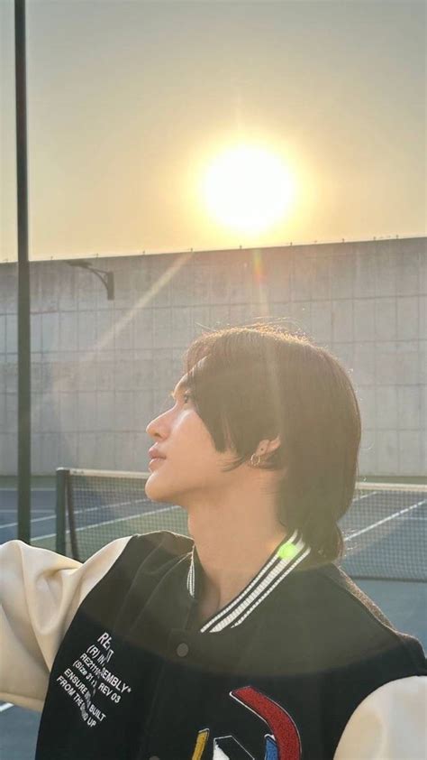 A Man Standing On Top Of A Tennis Court Holding A Racquet