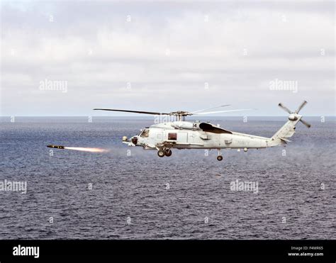 US Navy MH 60R Sea Hawk Helicopter Fires An AGM 114 Hellfire Missile