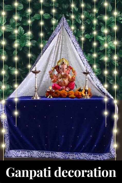 ganpati decoration with lights hanging from the ceiling and an image of ...