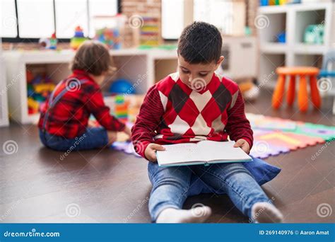 Two Kids Reading Book Sitting on Floor at Kindergarten Stock Photo - Image of kids, learning ...