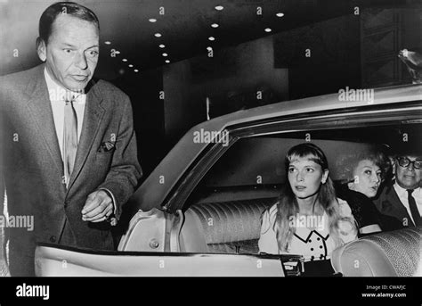 Frank Sinatra (1915-98) and Mia Farrow (b. 1945) prepare to leave the ...