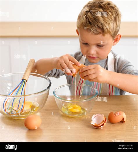 Boy Cracking Egg Into Bowl Years Stock Photo Alamy