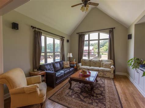 A Living Room Filled With Furniture And Windows