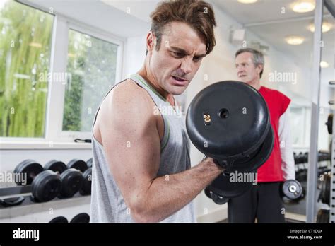 Man Lifting Weights In Gym Stock Photo Alamy