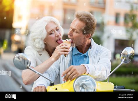 Mature Couple Sharing Ice Cream Stock Photo Alamy