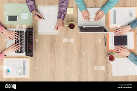 Coworkers And Business Team Working Together At Office Desk