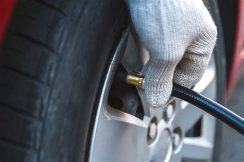 Premium Photo Pumping Car Tires In The Service Station