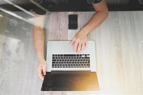 Top View Of Designer Hand Working With Laptop Computer And Smart Phone