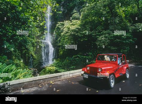 Couple in rental car Jeep at Wailua Falls Kipahulu District Hana Coast ...