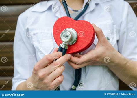 Female Doctor With A Stethoscope And A Red Heart In Her Hands Listen