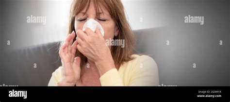 Mature Woman Blowing Her Nose Blurred Background Stock Photo Alamy